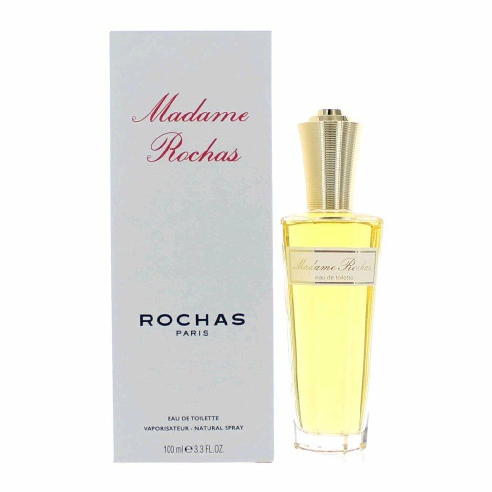 Flacone di profumo accanto alla confezione. Flacone con tappo dorato. Scritta: Madame Rochas Eau de Toilette.