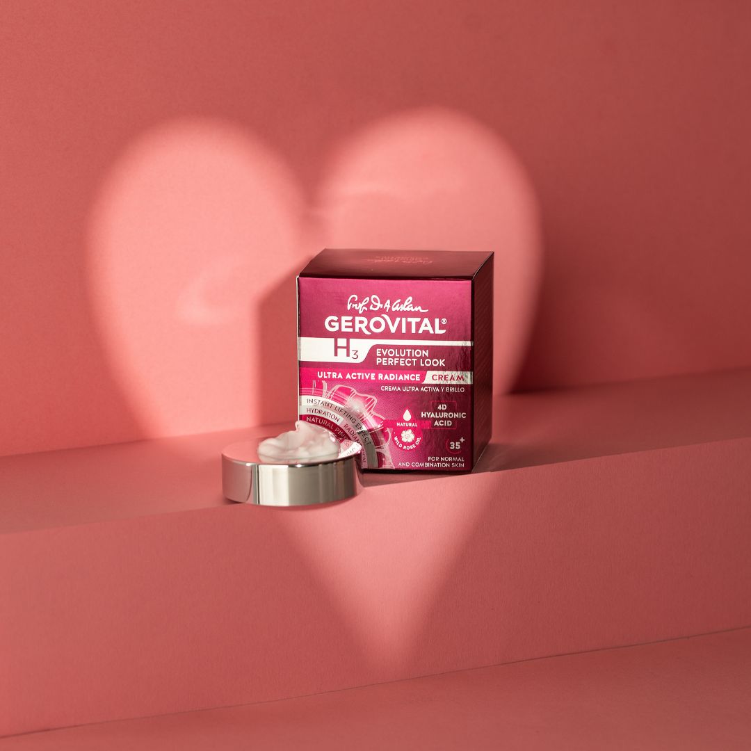 Vasetto di crema e scatola su sfondo rosa. Scritta: Gerovital, H3, Evolution Perfect Look. Ombra a forma di cuore.