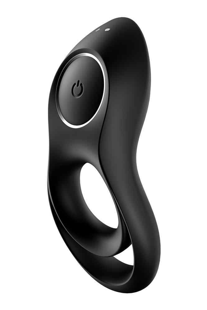 Vibratore ad anello nero con due fori e pulsante di accensione. Due piccoli punti in alto.