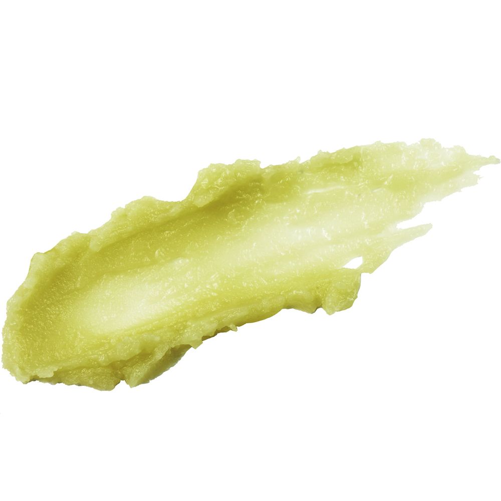 Texture di balsamo verde spalmata. Colore chiaro e cremoso. Su sfondo bianco.