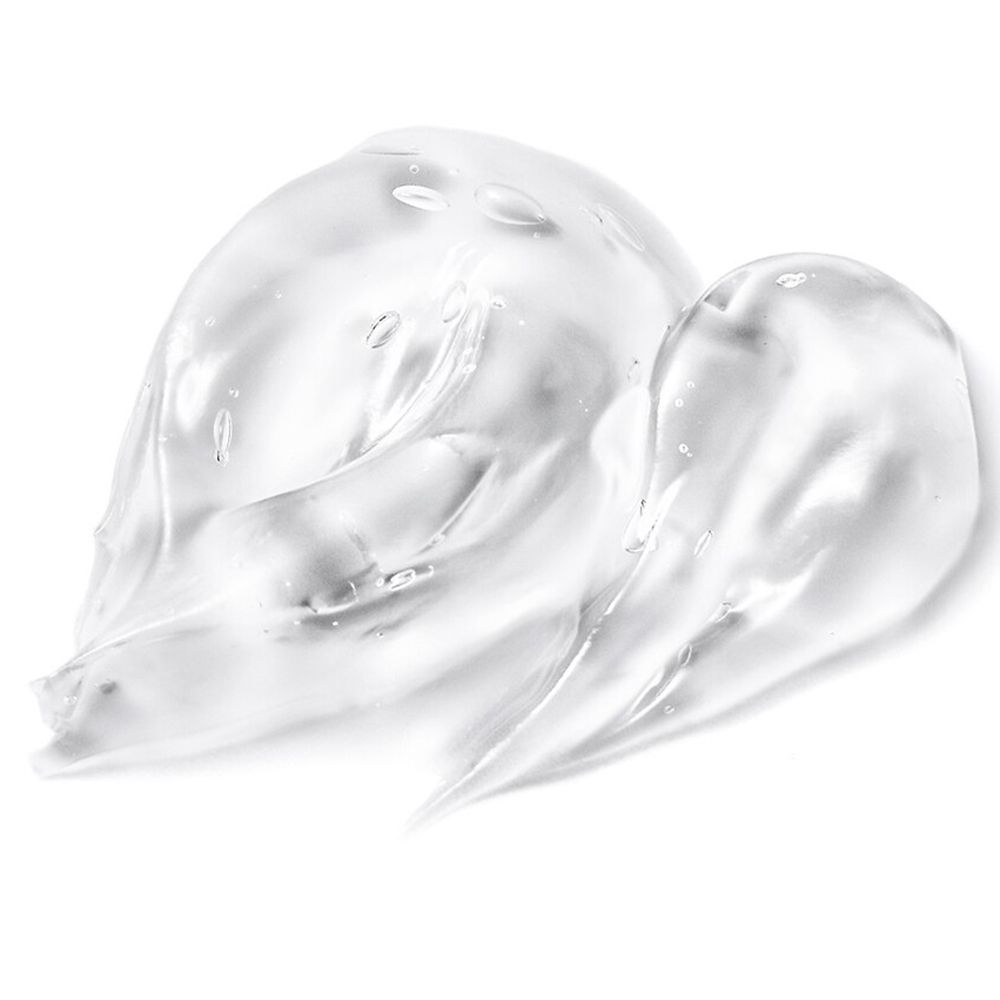 Sostanza gelatinosa trasparente, disposta a onde. Superficie strutturata con piccole bolle. Su sfondo bianco.