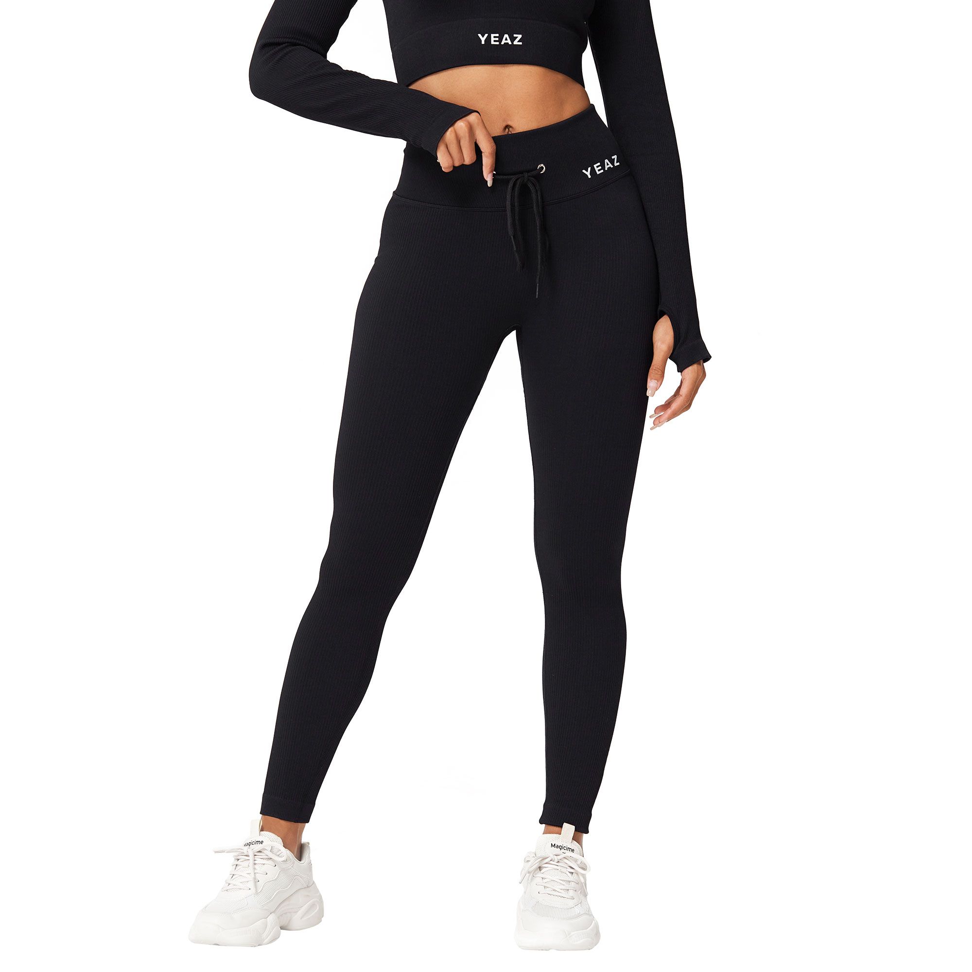 Leggings neri a coste con coulisse e logo del marchio 'YEAZ'.