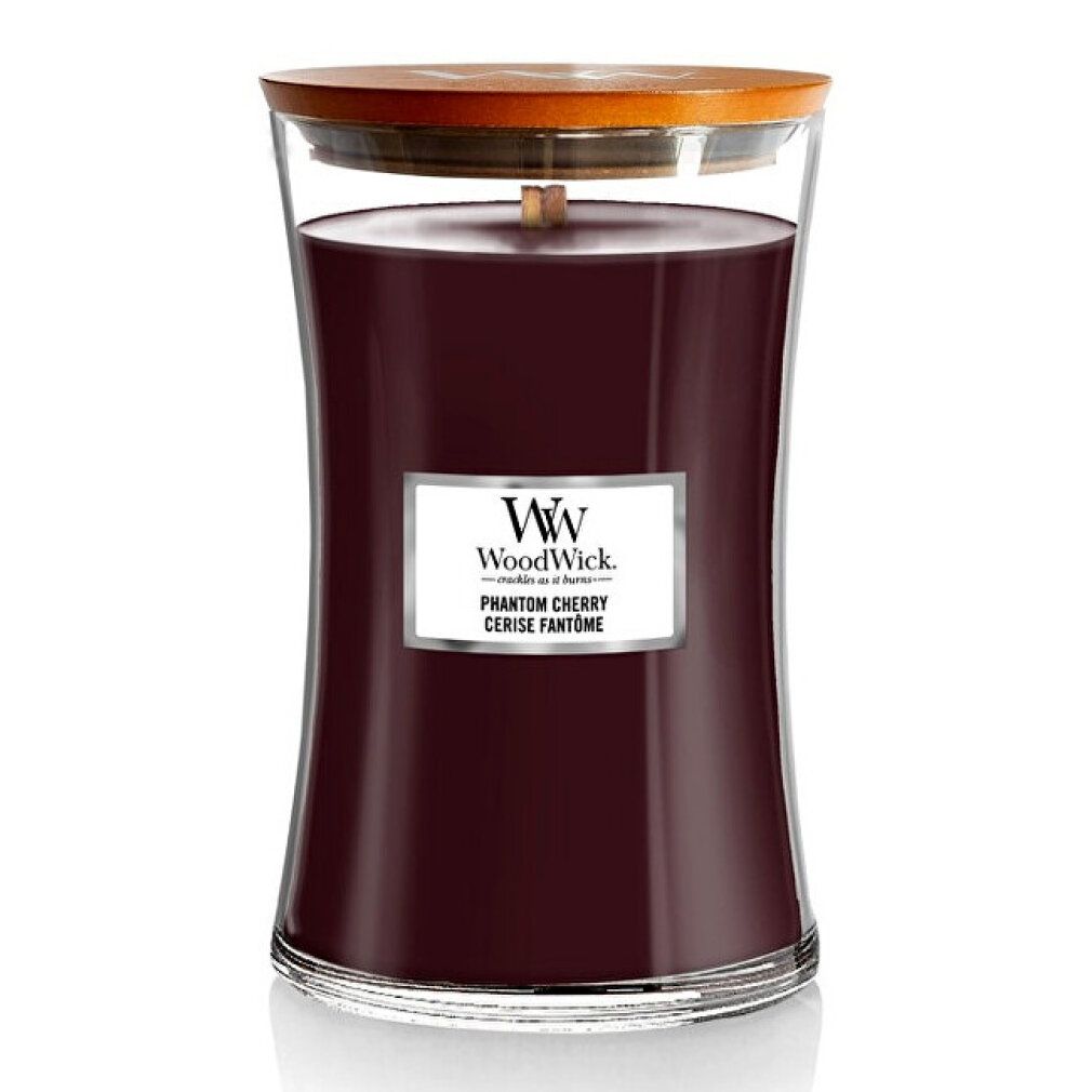 Candela profumata in vetro con stoppino in legno e coperchio. Etichetta "WoodWick Phantom Cherry". Cera rosso scuro.