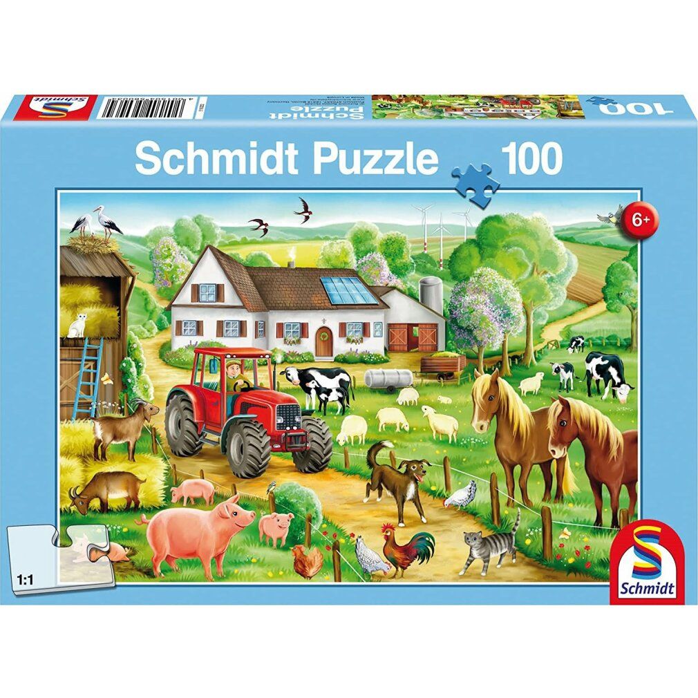 Puzzle in confezione. Motivo fattoria, 100 pezzi. Marchio Schmidt Puzzle. Scatola blu con pezzo di puzzle.
