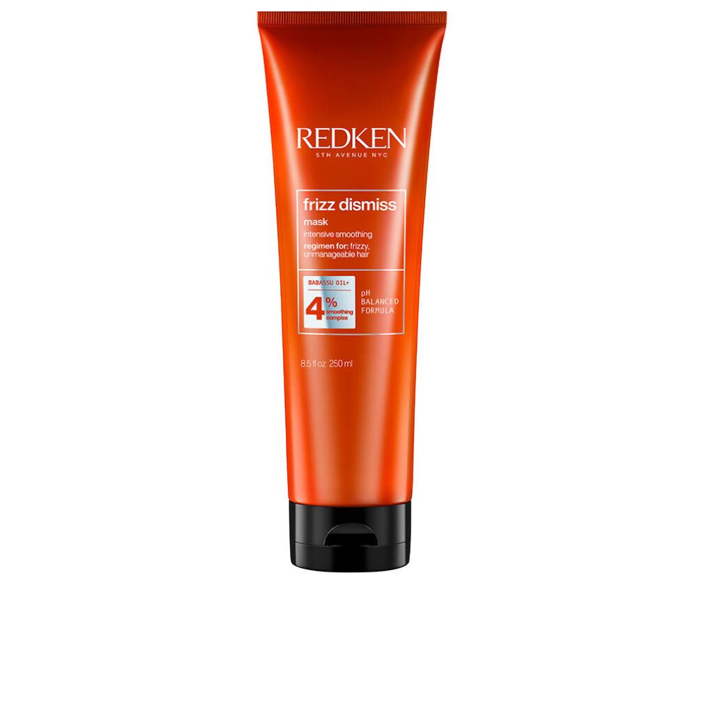 Tubo arancione con tappo nero. Scritta: Redken, Frizz Dismiss Mask. Contiene olio di babassu e complesso lisciante. pH bilanciato.