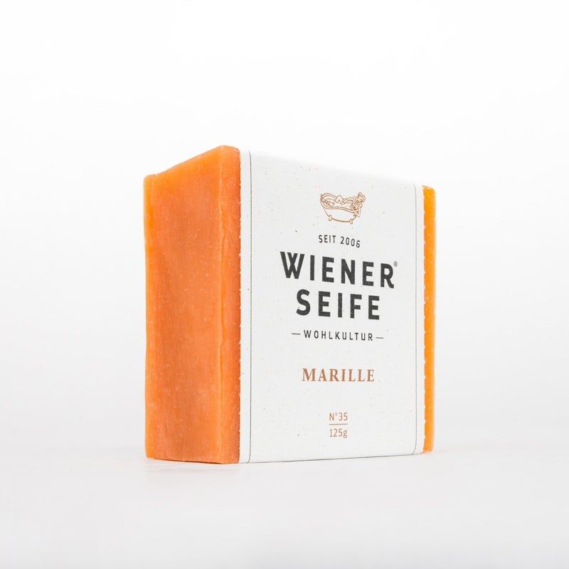 Sapone arancione con fascia di carta. Scritta: Wiener Seife, Marille, N°35, 125g.