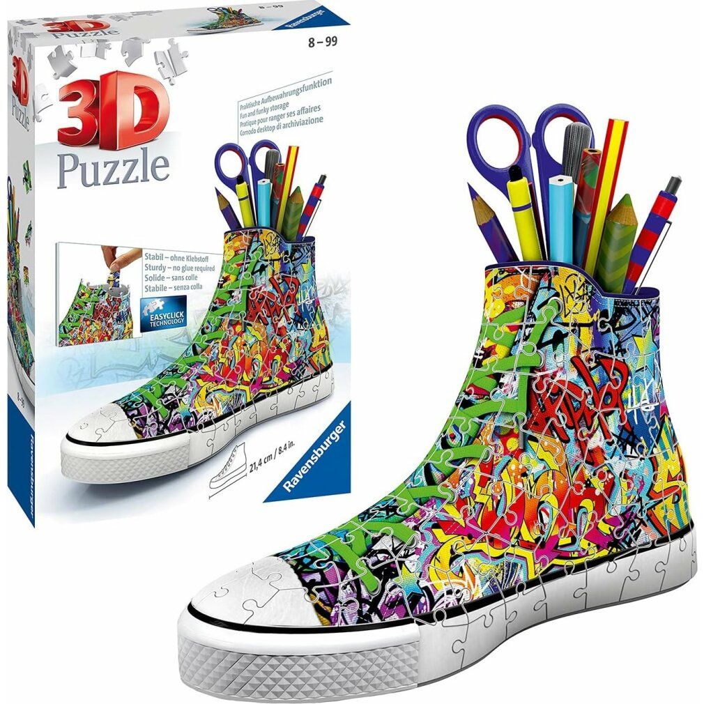 Puzzle 3D Sneaker Graffiti, confezionato. Forma di scarpa, design graffiti colorato. Contiene penne, forbici. Logo Ravensburger. 21,4 cm.