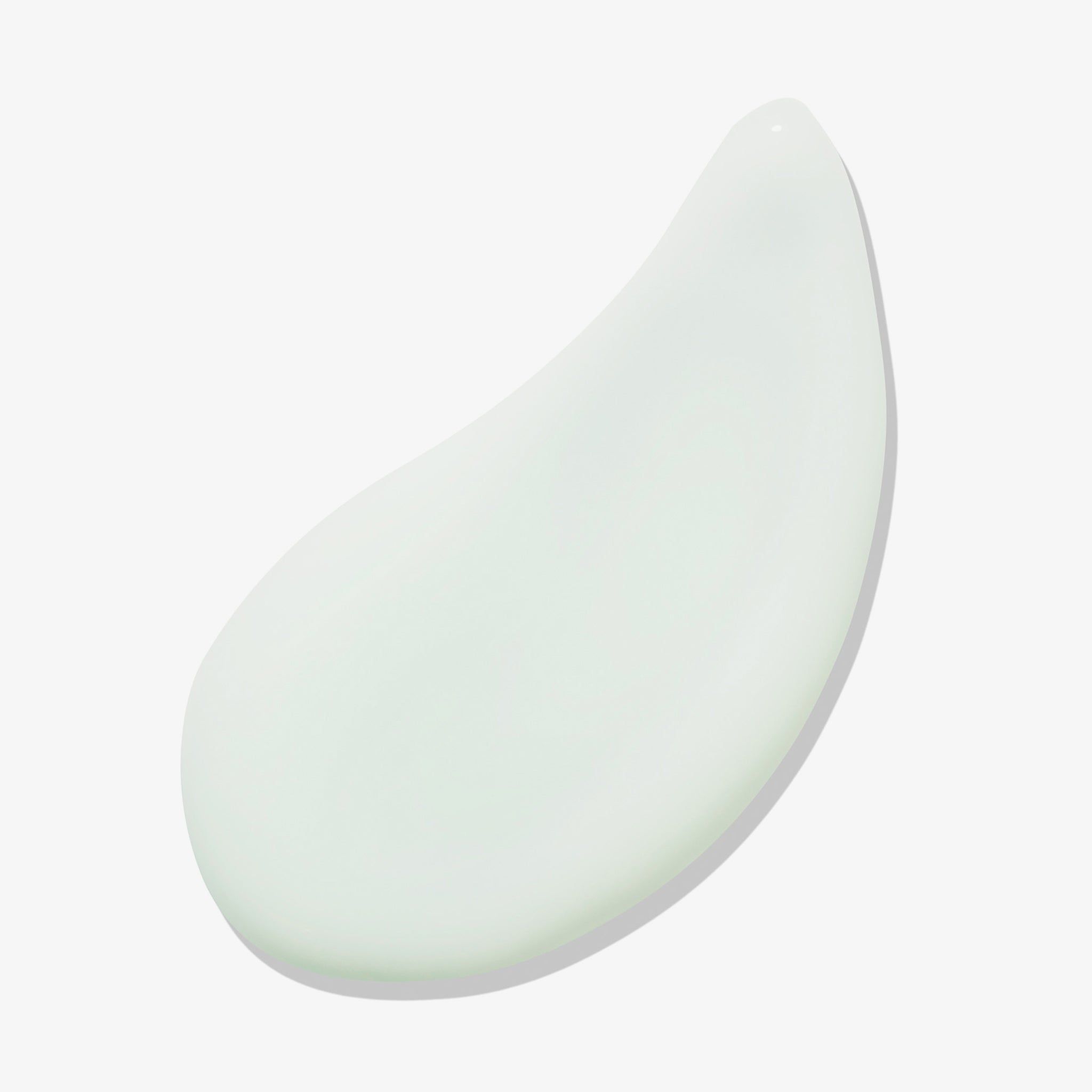 Goccia di gel verde chiaro su sfondo bianco.