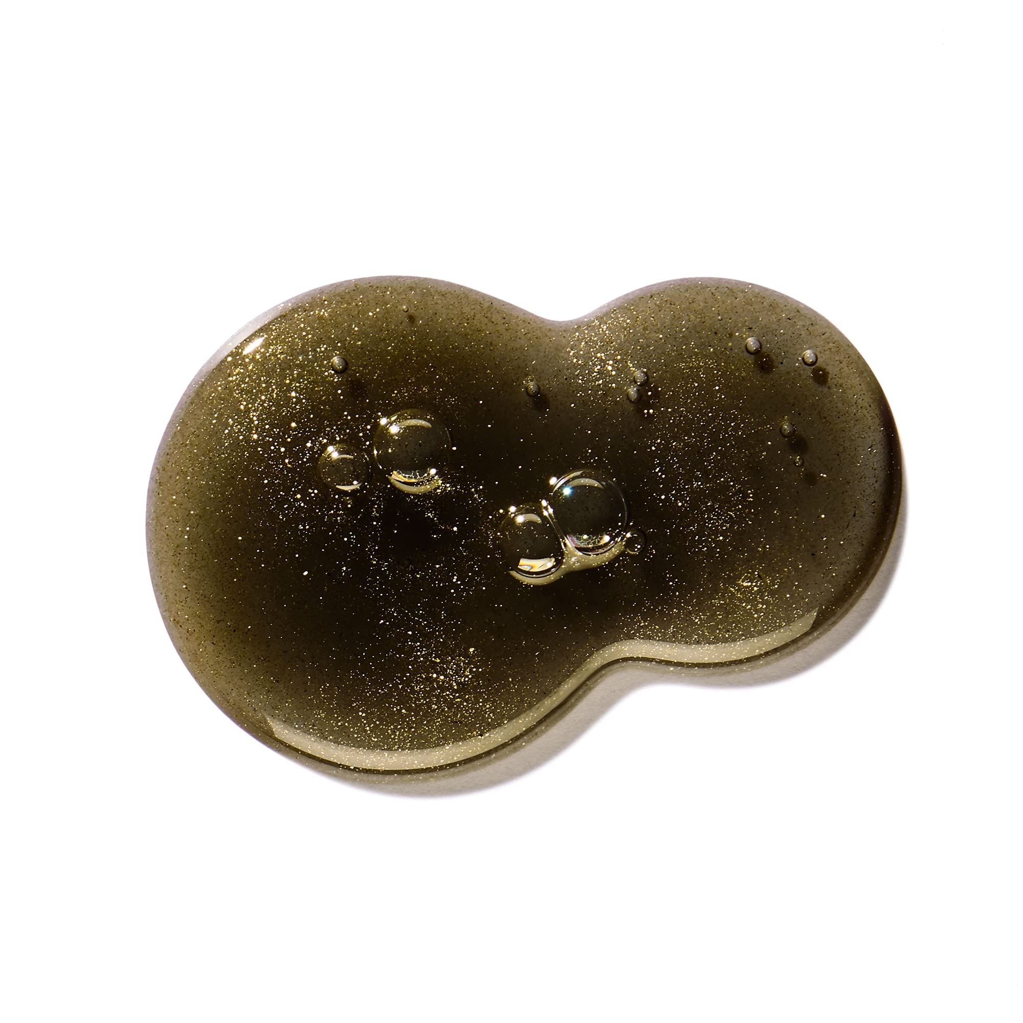 Goccia di bagnoschiuma e docciaschiuma Molton Brown Labdanum Dusk con particelle dorate e bolle d'aria.