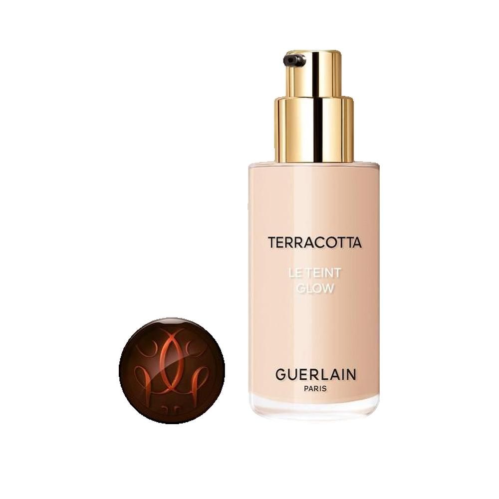 Flacone beige con erogatore dorato. Scritta: Terracotta Le Teint Glow. Marchio: Guerlain. Sfera.