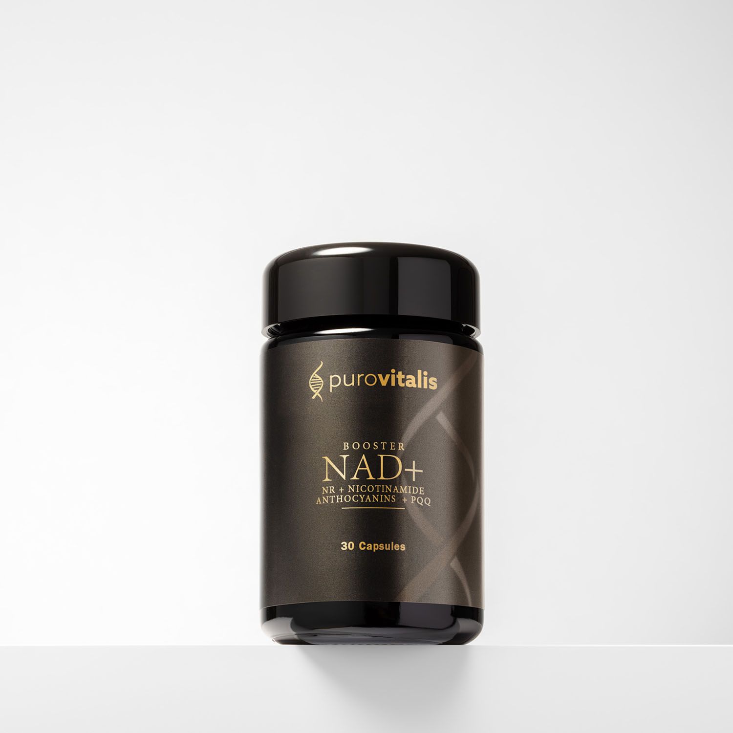 Barattolo nero con coperchio nero. Scritta: Booster NAD+, 30 capsule. Logo: Purovitalis. Su una mensola bianca.