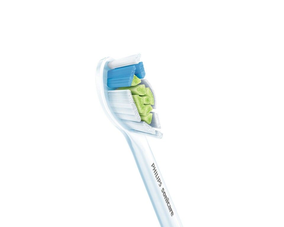 Primo piano di una testina bianca Philips Sonicare. Setole verdi e blu. Scritta "Philips Sonicare".