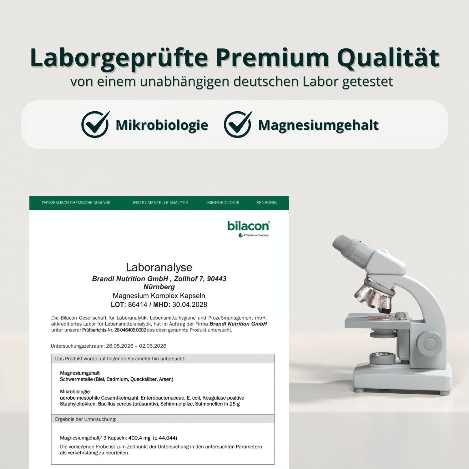 Barattolo Magnesio-Komplex con sigilli per microbiologia e contenuto di magnesio, un microscopio accanto.