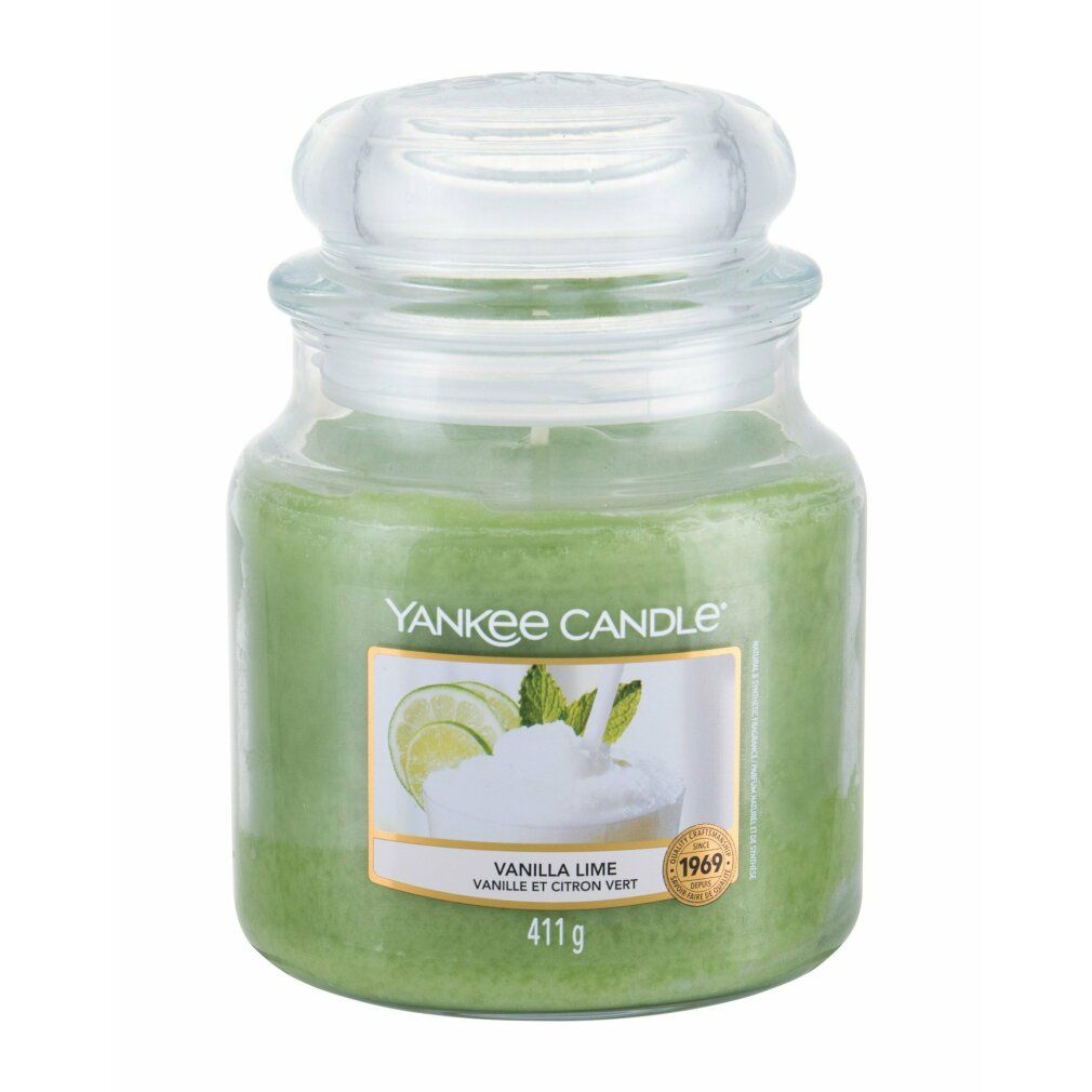 Candela verde in vaso con coperchio. Etichetta con motivo vaniglia-lime. Scritta: Vanilla Lime. Contenitore di vetro.