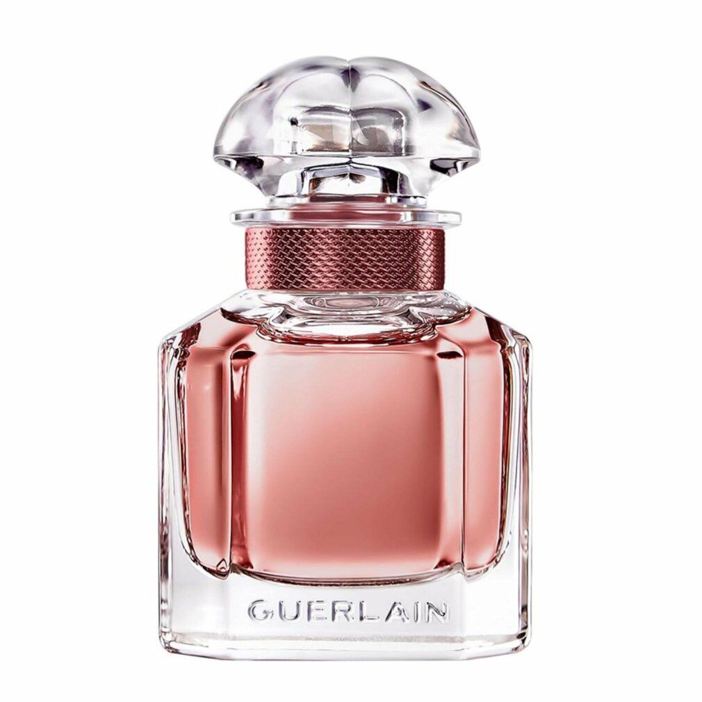 Flacone in vetro con liquido rosa. Tappo trasparente. Anello rosa attorno al collo. "GUERLAIN" in basso.