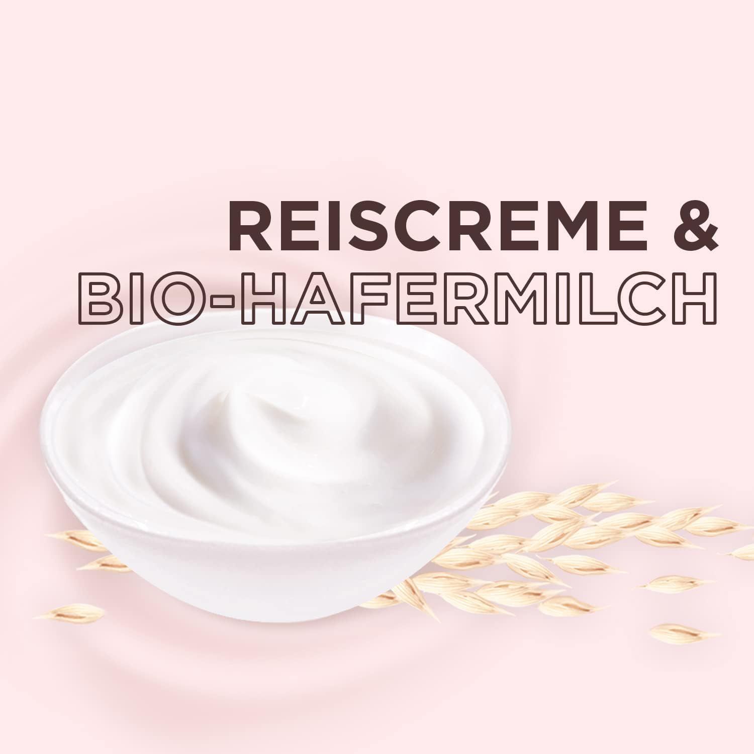 Testo su sfondo rosa: Crema di riso e latte d'avena bio. Crema bianca in una ciotola, accanto alle spighe d'avena.