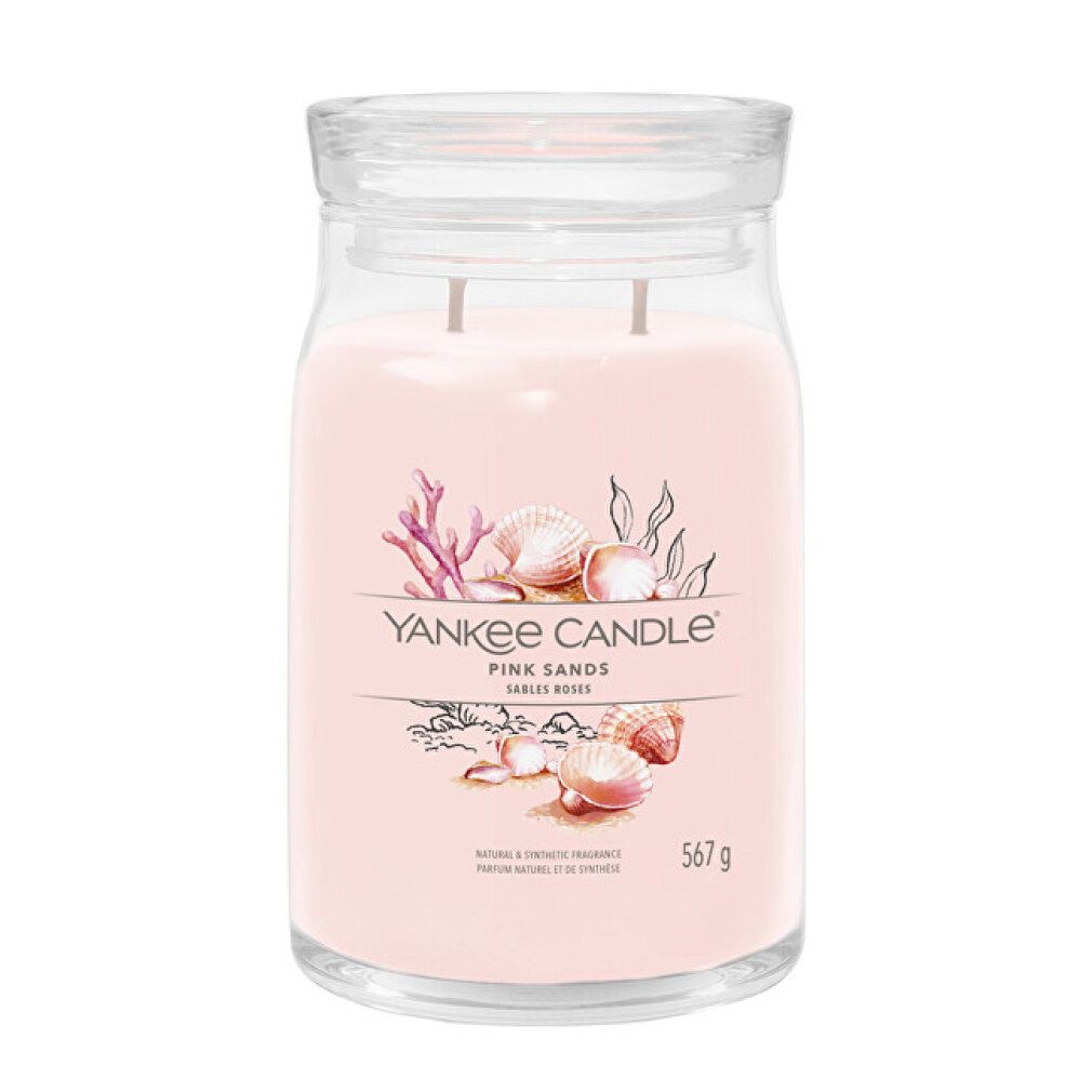 Una grande candela profumata Yankee Candle rosa in barattolo di vetro con coperchio. L'etichetta mostra conchiglie e corallo.
