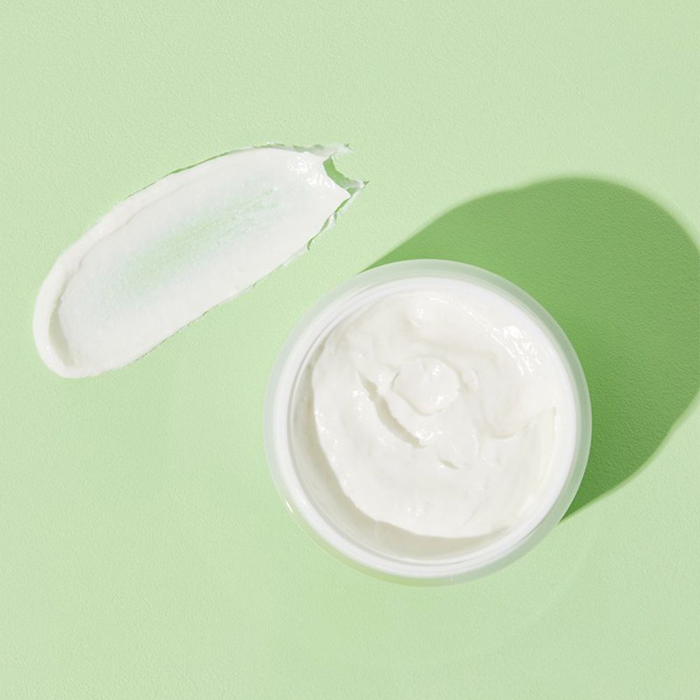 Crema COSRX Centella Blemish, vasetto aperto con crema e una macchia accanto.