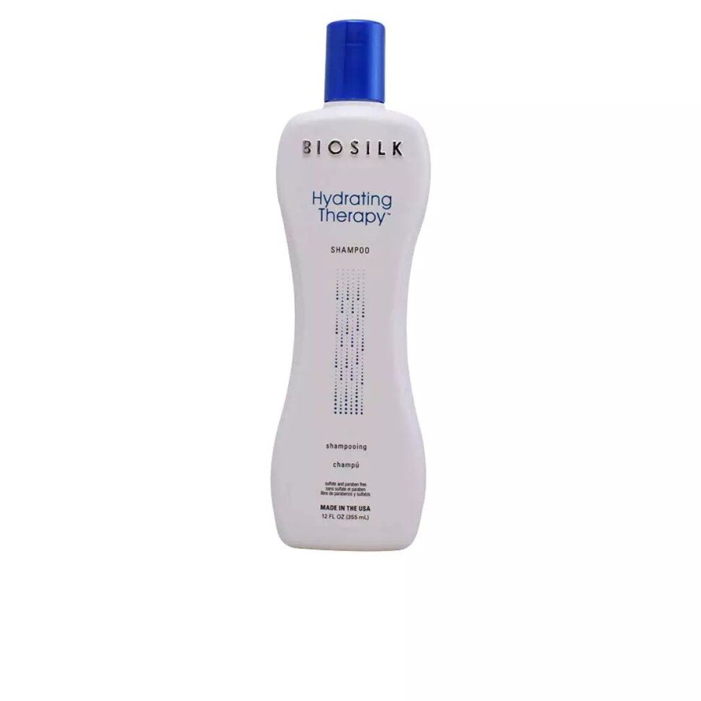 Flacone bianco con tappo blu. Scritta: Biosilk Hydrating Therapy Shampoo. Forma verticale, parte centrale stretta.