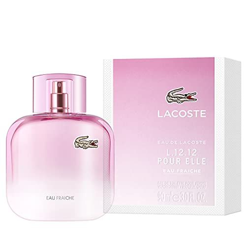 Flacone rosa con vaporizzatore e confezione bianca. Logo coccodrillo. Testo: L.12.12 POUR ELLE, Eau Fraiche.