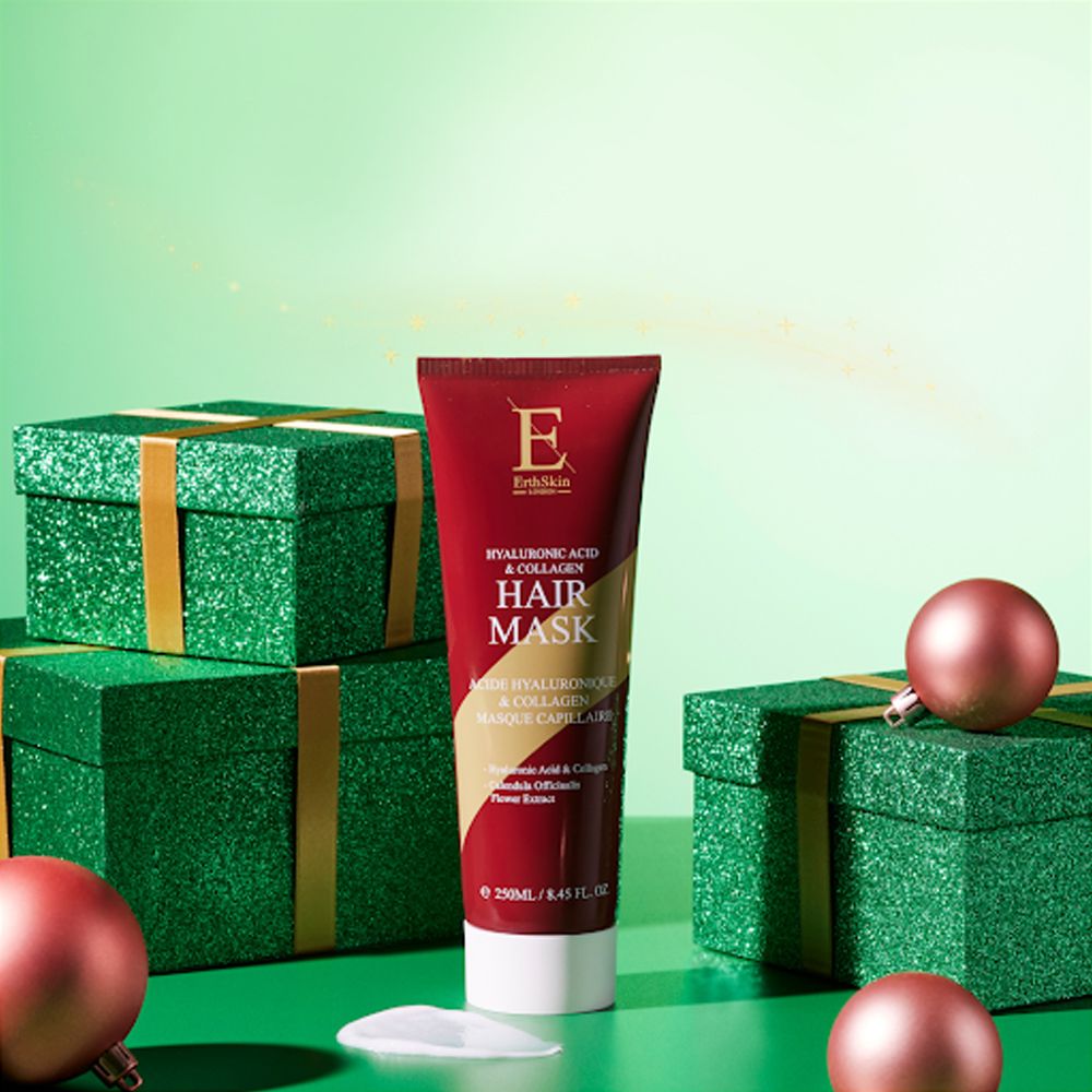 Tubo rosso di maschera per capelli all'acido ialuronico e collagene, circondato da scatole regalo verdi e palline rosa.