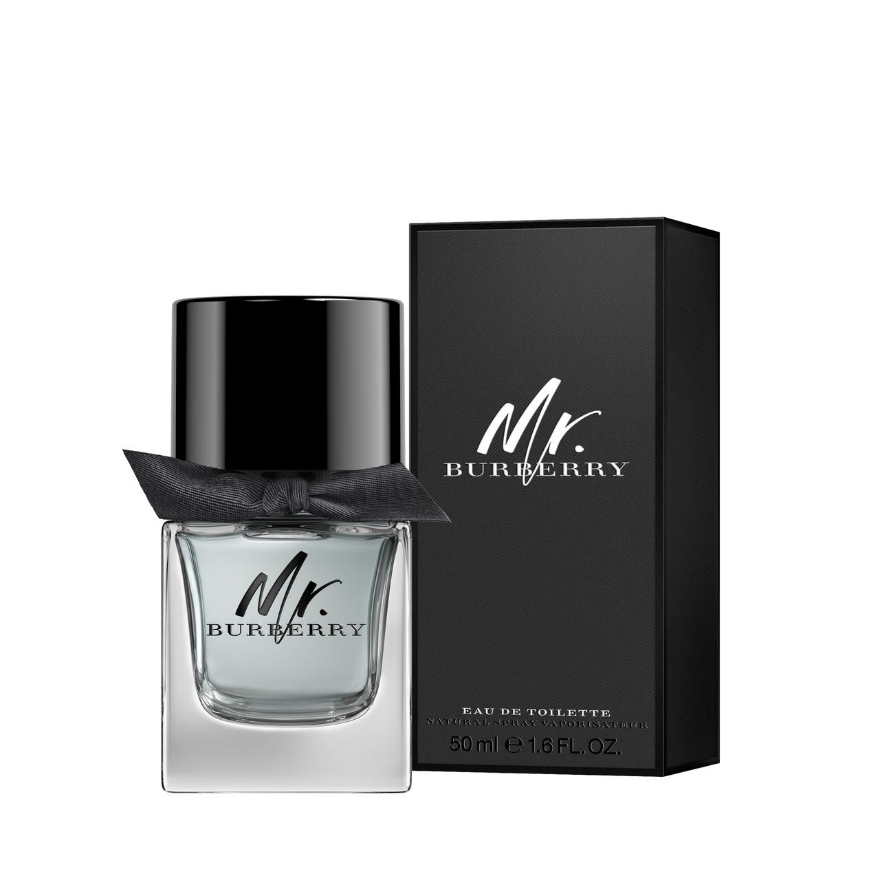 Flacone nero con tappo nero e fiocco. Scatola nera con scritta "Mr. Burberry". Testo: Eau de Toilette.