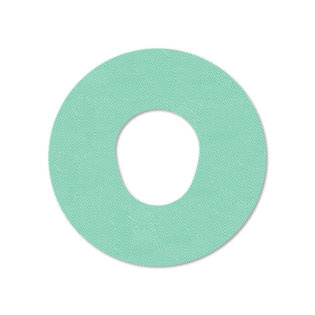 Cerotto di fissaggio rotondo, verde chiaro, con texture. Foro centrale.