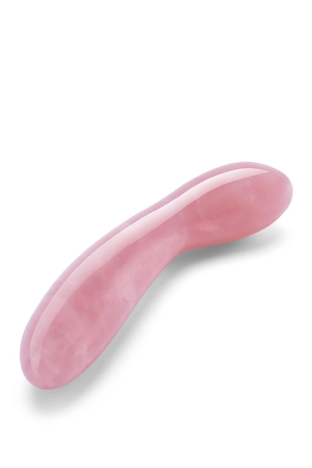 Bacchetta curva rosa in quarzo rosa. Superficie liscia, forma arrotondata. Prodotto benessere.