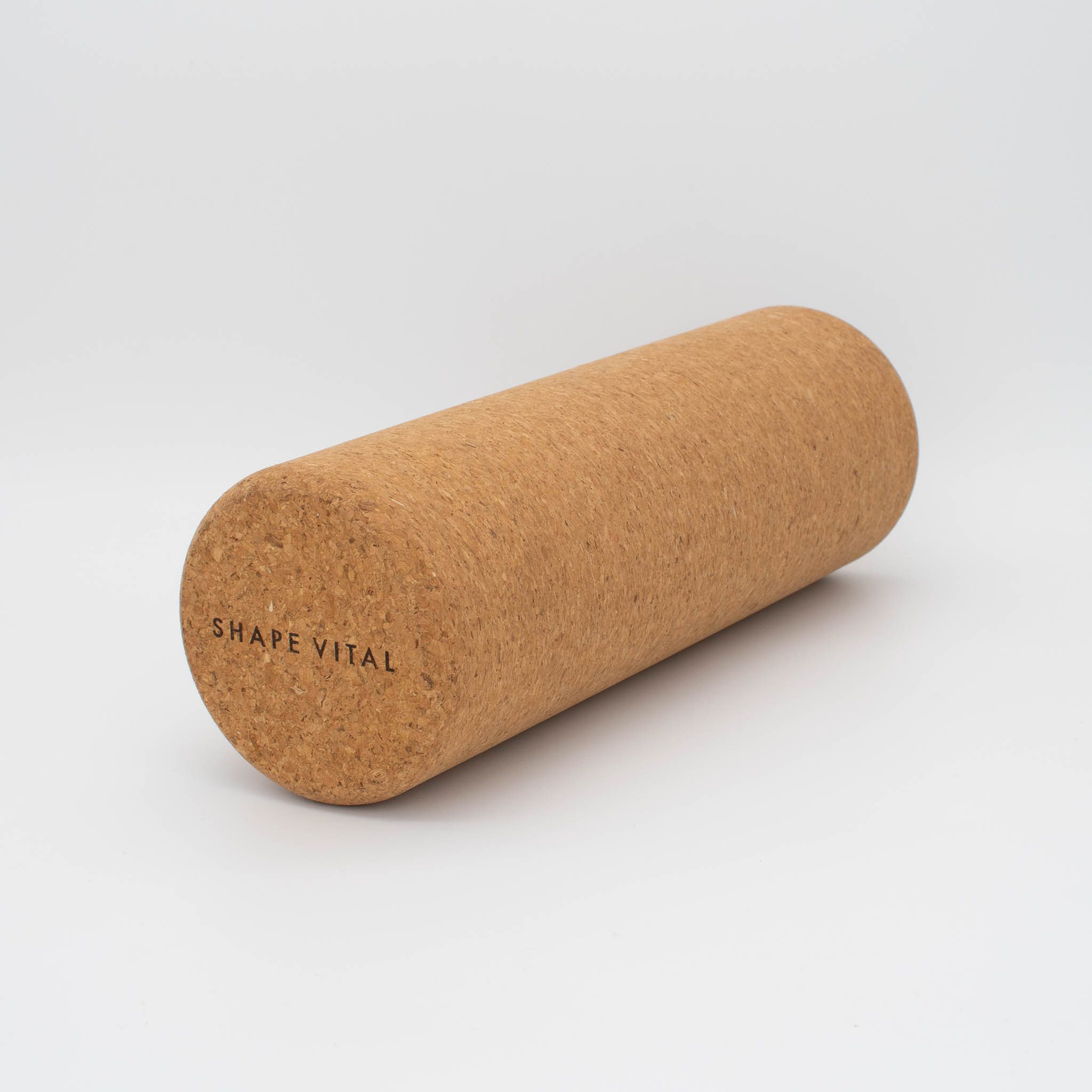 Rullo per fascia in sughero. Cilindrico, marrone. "SHAPE VITAL" stampato su un lato.