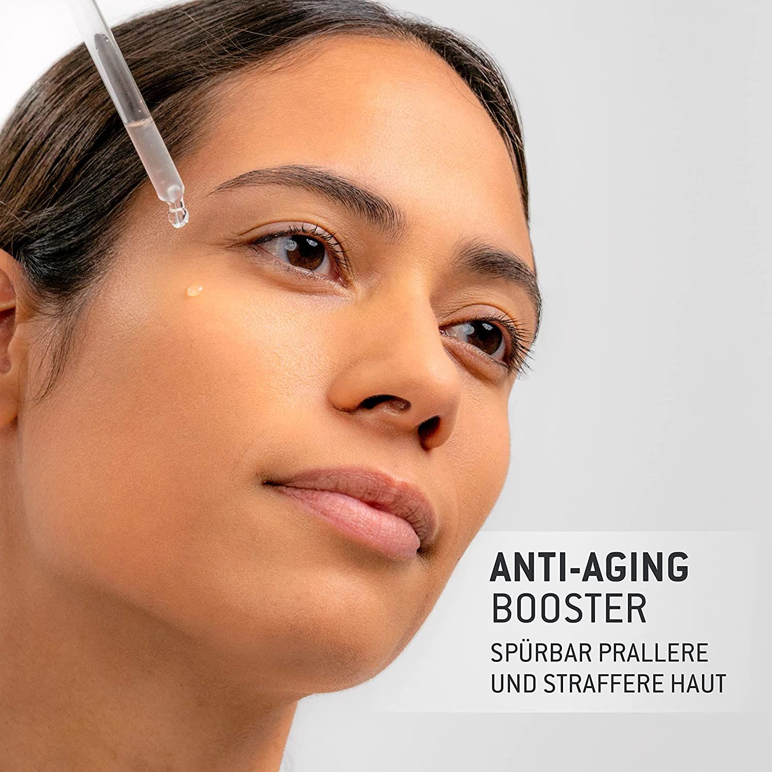 Donna con siero sulla pelle. Testo: Anti-Aging Booster. Flacone con pipetta. Goccia di siero sulla pelle.