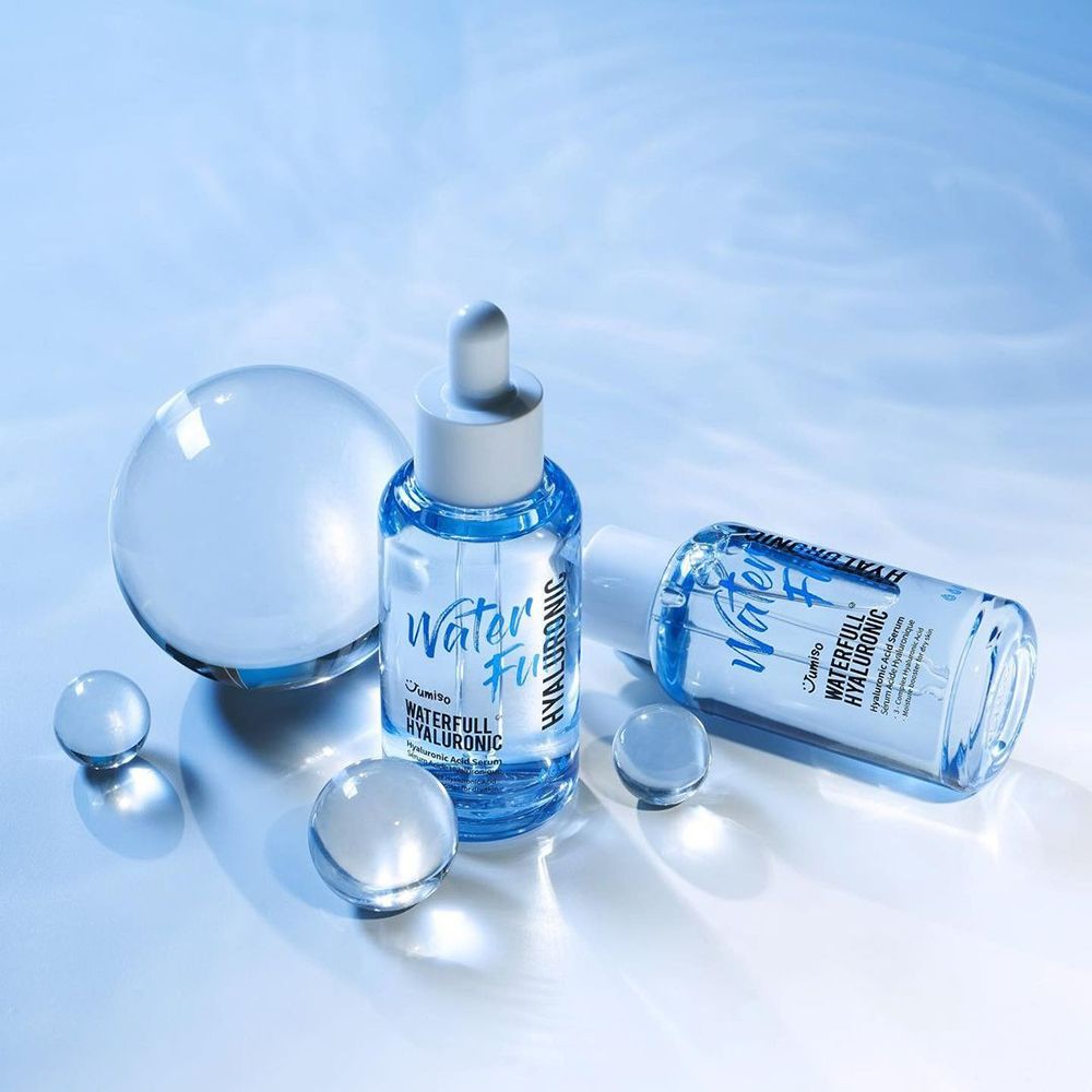 Due flaconi di siero e sfere trasparenti. Scritta: Waterfull Hyaluronic. Un flacone è sdraiato.