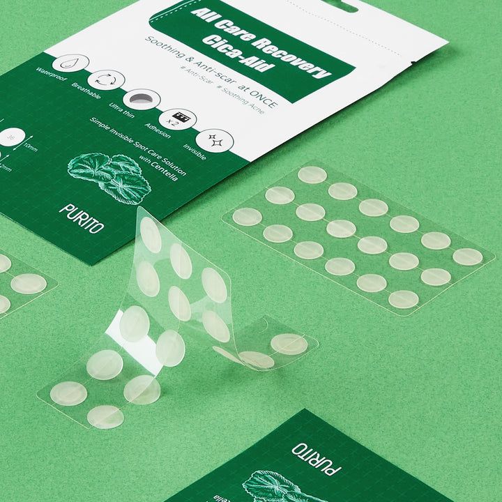Cerotti rotondi trasparenti su supporto. Alcuni cerotti sono staccati. Design confezione verde e bianco. Marchio: PURITO.