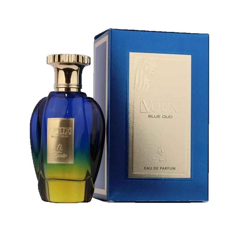 Flacone di profumo blu-giallo con tappo dorato e scatola blu. Scritta: Voux Blue Oud Eau de Parfum.