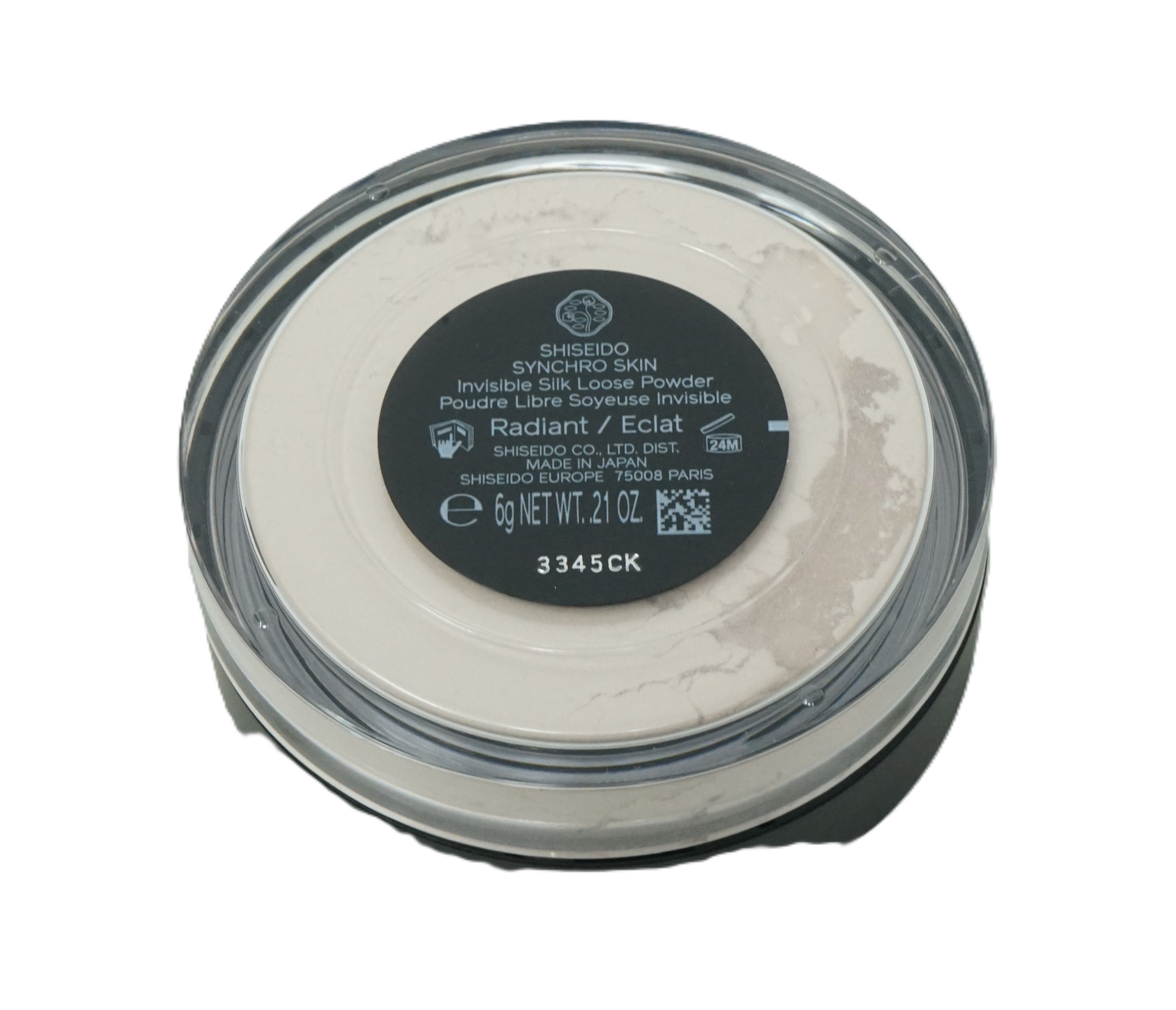 Contenitore rotondo trasparente con cipria libera. Coperchio nero con informazioni sul prodotto. Marca: Shiseido. Contenuto: 6g.