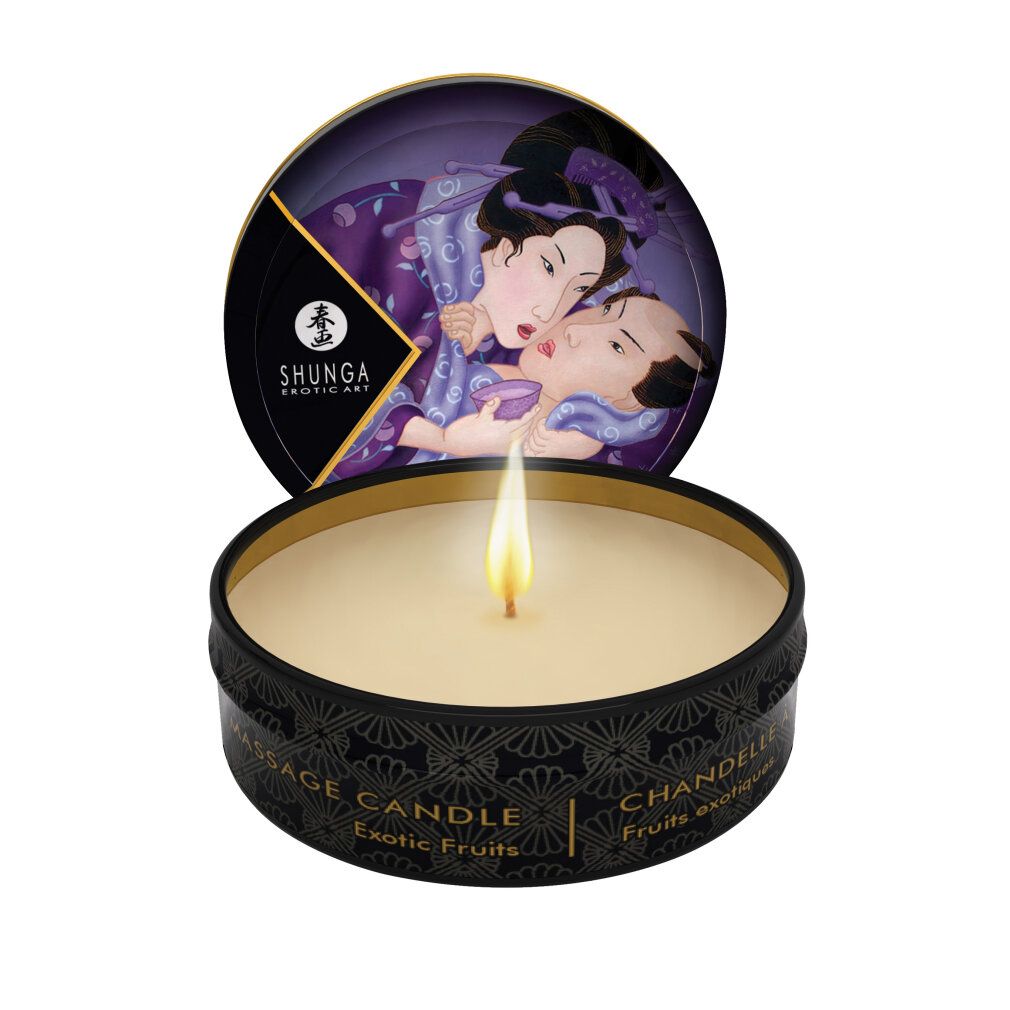 Candela da massaggio Shunga Libido/Exotic Fruits in scatola nera, fiamma accesa. Coperchio con arte erotica.