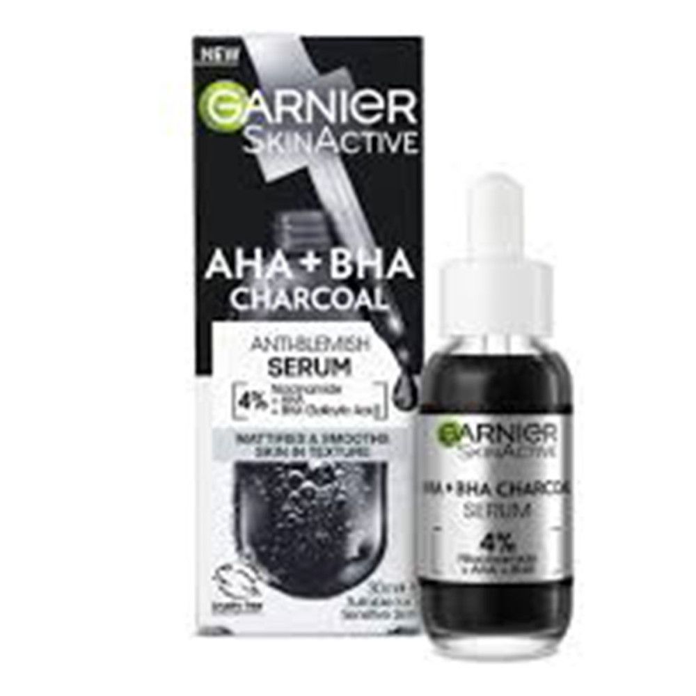 Flacone di siero e confezione. Scritta: Garnier SkinActive AHA+BHA Charcoal Anti-Blemish Serum, 4% Niacinamide + AHA + BHA.