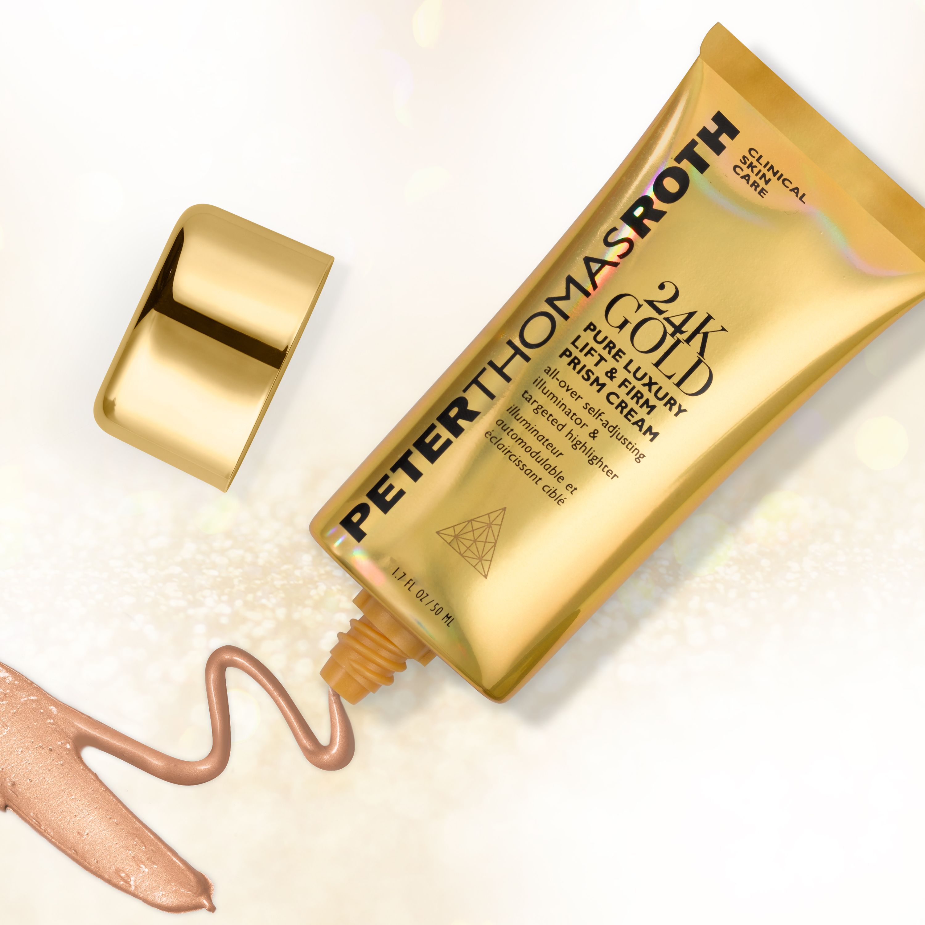 Tubo dorato, tappo accanto. Nome del prodotto e testo. Peter Thomas Roth 24K Gold Pure Luxury Lift & Firm Prism Cream. Flusso di crema.