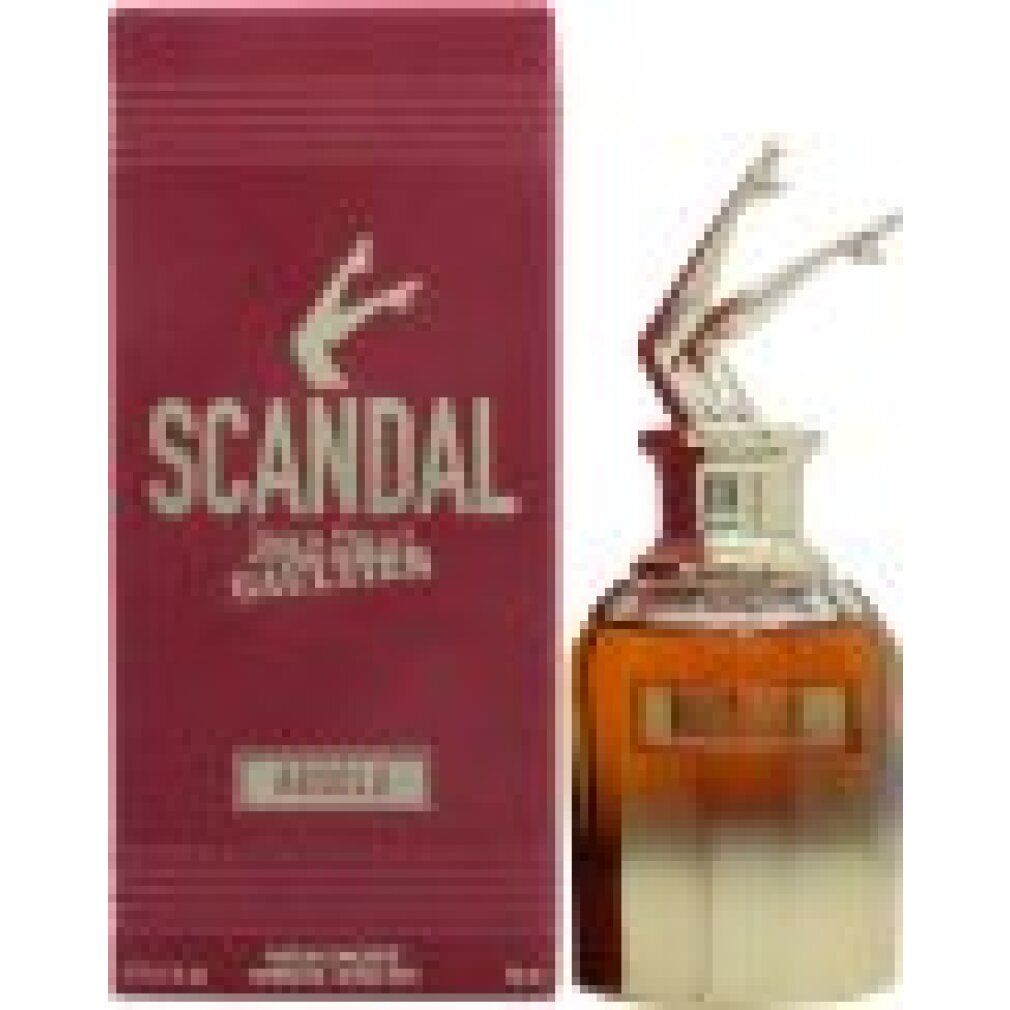 Flacone di profumo con tappo dorato a forma di gambe. Accanto, una scatola bordeaux con la scritta SCANDAL.