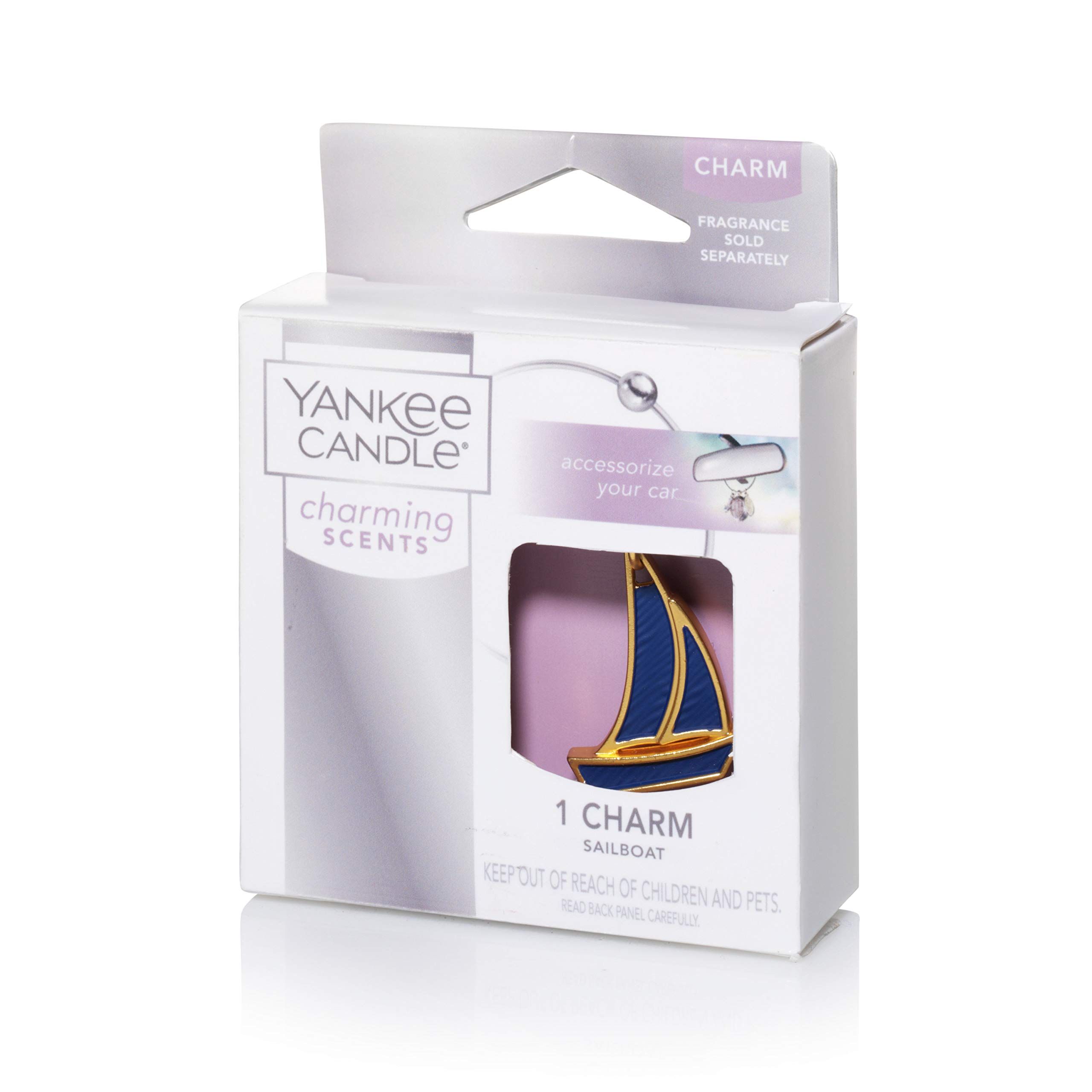Confezione con charm a forma di barca a vela. Charm oro e blu. Marchio: Yankee Candle.