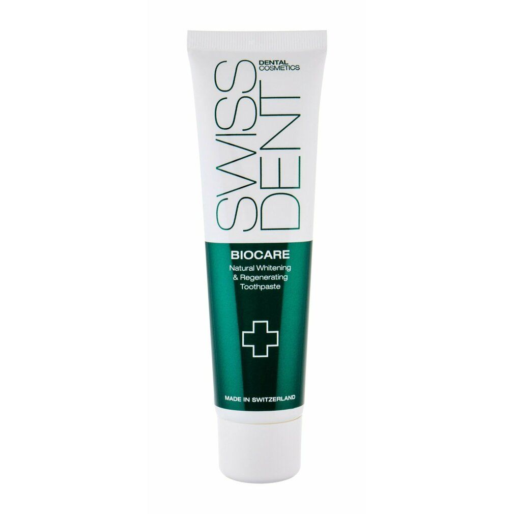 Tubo di dentifricio bianco e verde. Scritte: SWISSDENT, BIOCARE, Natural Whitening & Regenerating Toothpaste. Croce verde.