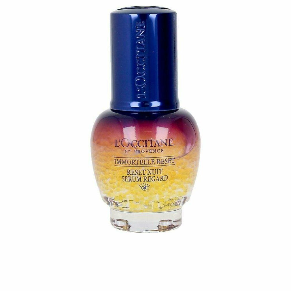 Flacone di siero con tappo blu. Scritte: L'Occitane, Immortelle Reset, Reset Nuit Serum Regard. Sferette gialle nella parte inferiore.