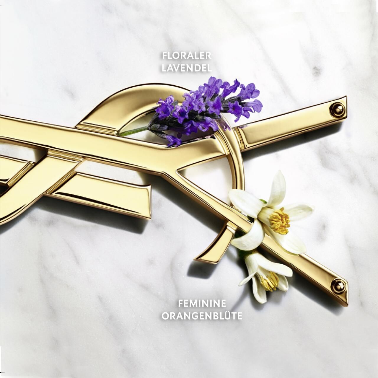 Primo piano del logo dorato con lavanda e fiori d'arancio. Testo: 'FLORALER LAVENDEL' e 'FEMININE ORANGENBLÜTE'.