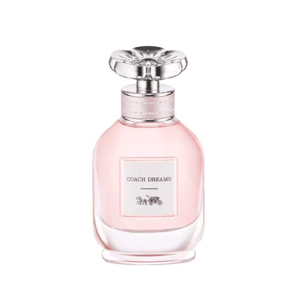 Flacone di profumo rosa. Etichetta "COACH DREAMS" e logo carrozza. Tappo trasparente.