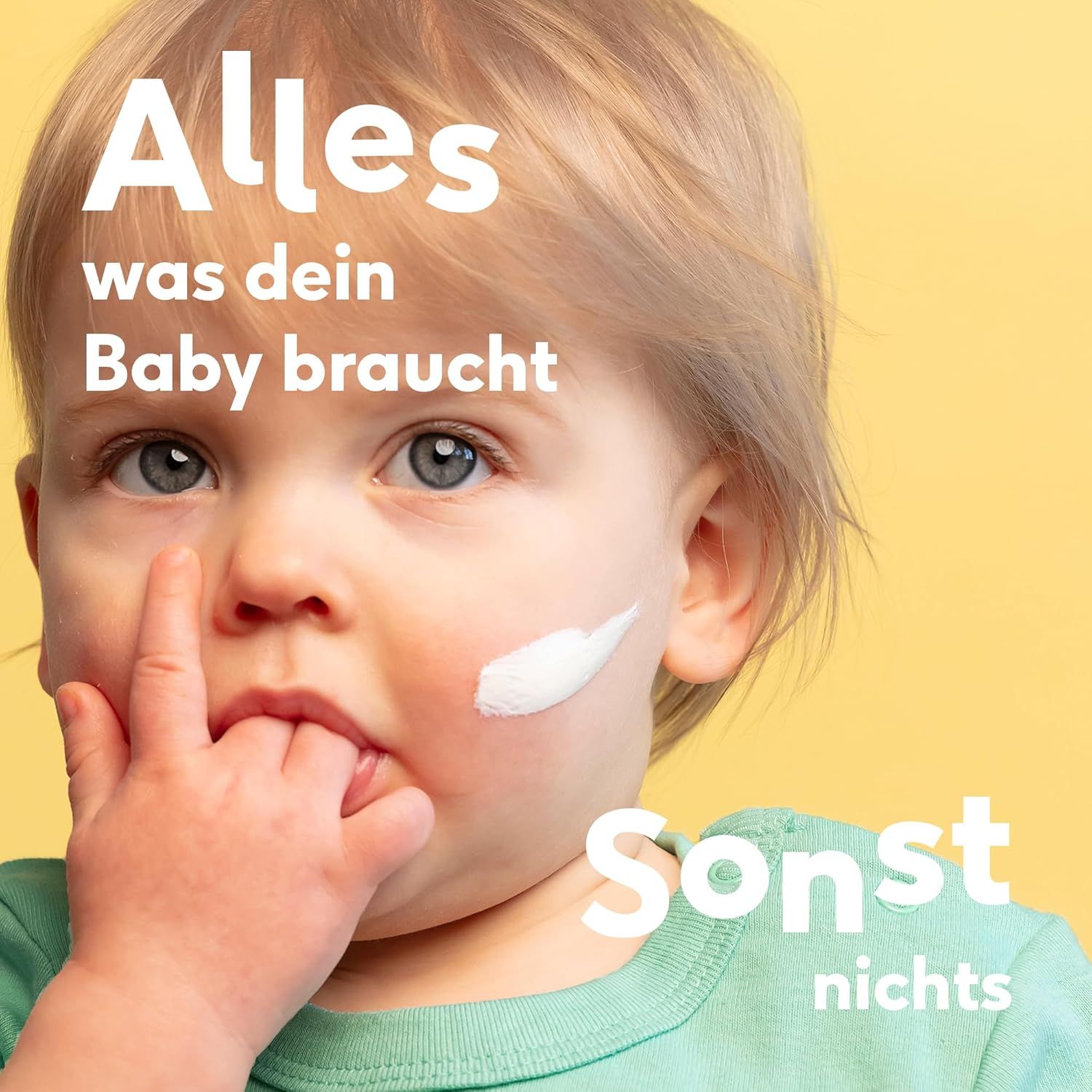 Bambino con crema sul viso. Testo: Tutto ciò di cui il tuo bambino ha bisogno, nient'altro.