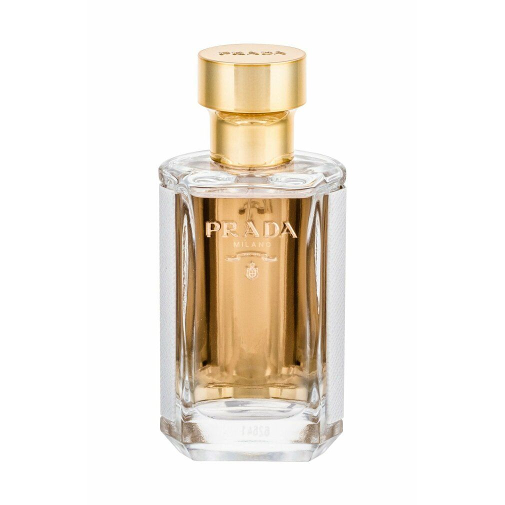 Flacone di profumo rettangolare con tappo dorato. Contenuto dorato, lati bianchi. Logo Prada dorato.