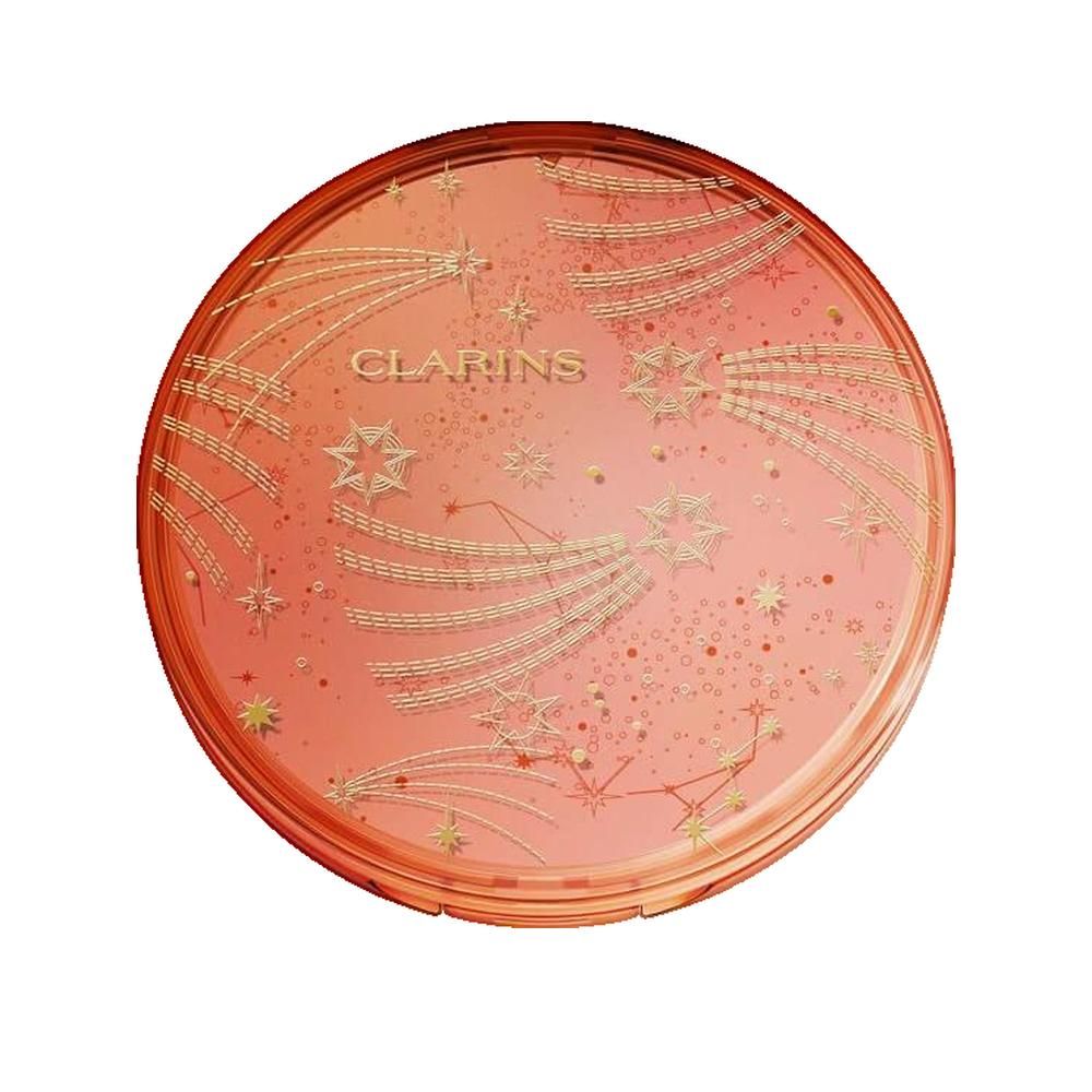 Polvere bronzante compatta rotonda chiusa. Coperchio con motivo a stelle e testo. Sfumatura di colore rosa-arancio.