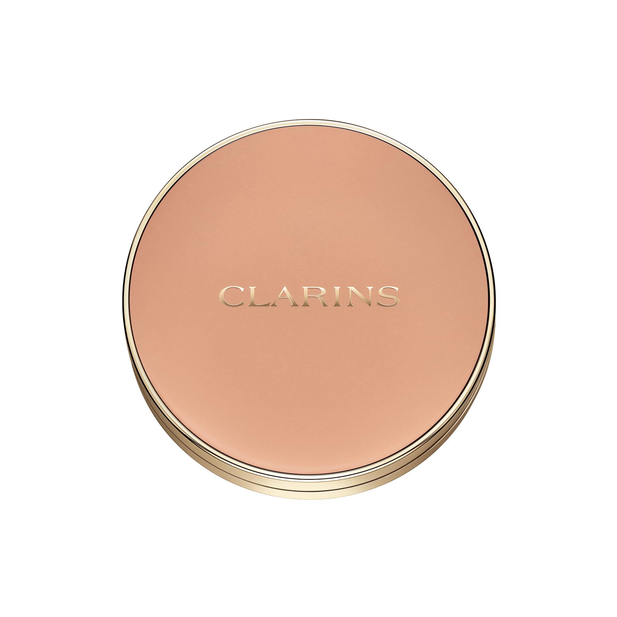 Cipria compatta chiusa con logo CLARINS. Forma rotonda, bordo dorato, colore chiaro.