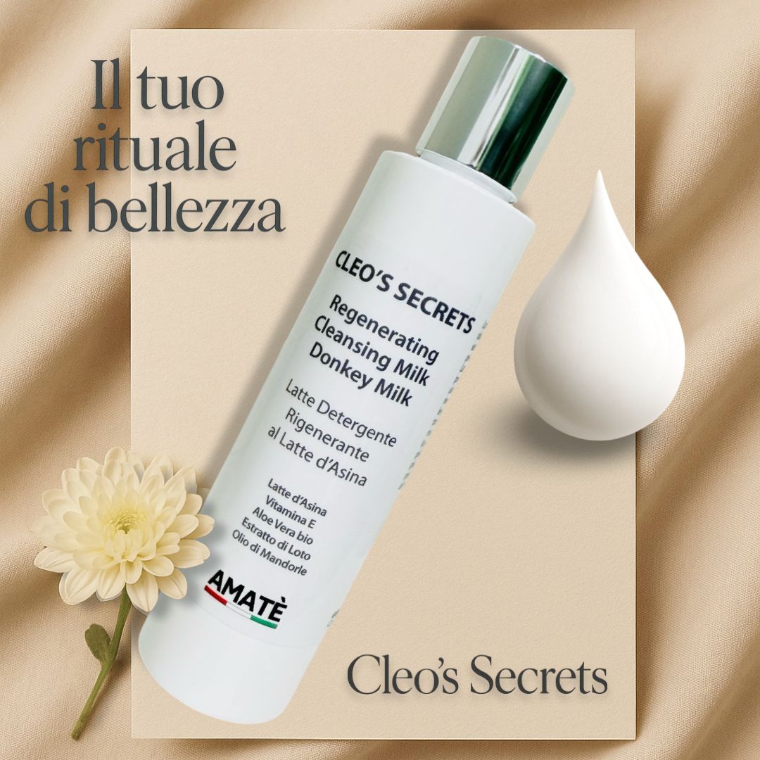 Flacone bianco con tappo argentato. Testo: Cleo's Secrets, Regenerating Cleansing Milk Donkey Milk. Marchio Amatè.