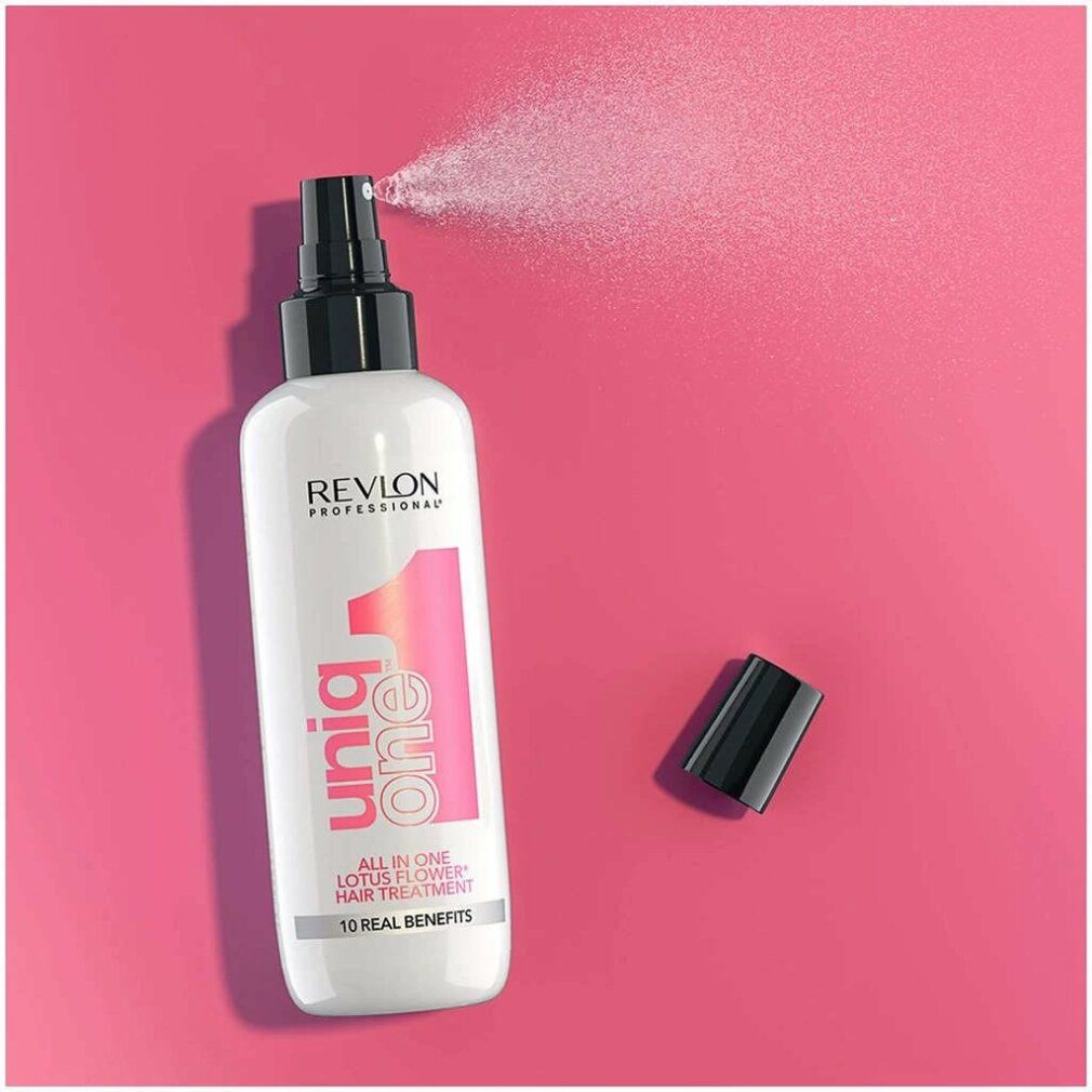 Flacone bianco con vaporizzatore nero. Stampa rosa: Uniq One, Lotus Flower Hair Treatment. Marchio: Revlon. Nebulizzazione.