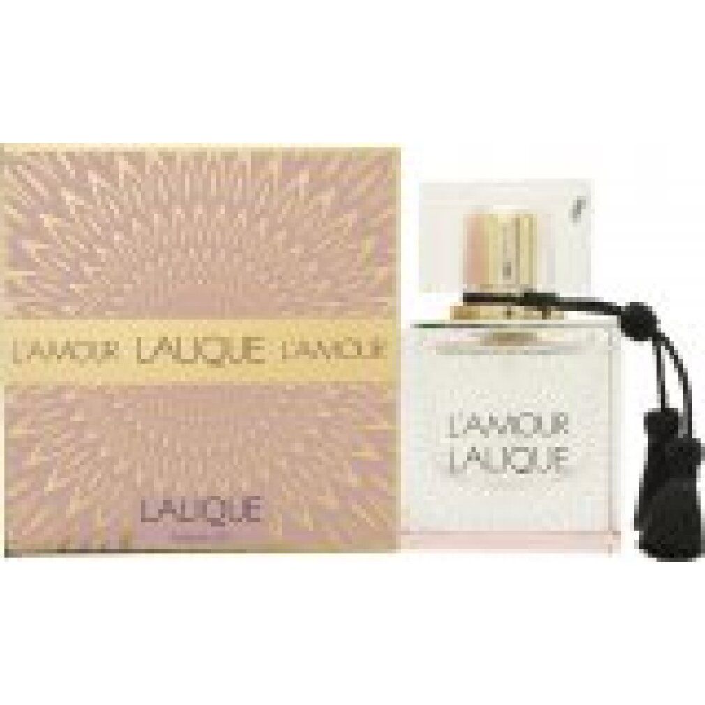 Flacone di profumo accanto alla confezione. Flacone con tappo dorato e nappe. Scritta: L'AMOUR LALIQUE.